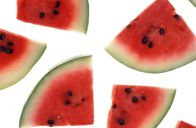 A whole watermelon and cut slices